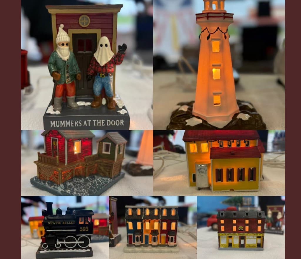 Newfoundland-inspired light-up village pieces including mummers, lighthouse, row houses, and the Newfie Bullet